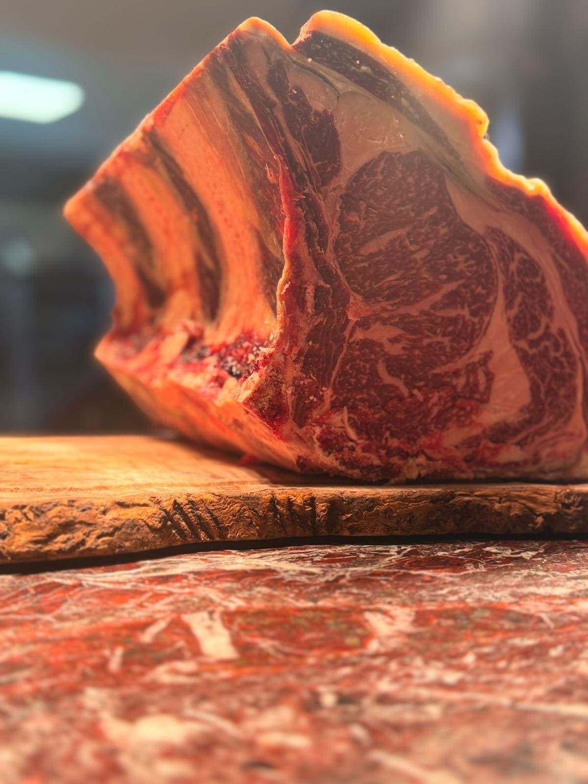 Côte de bœuf posée près du couteau du boucher
